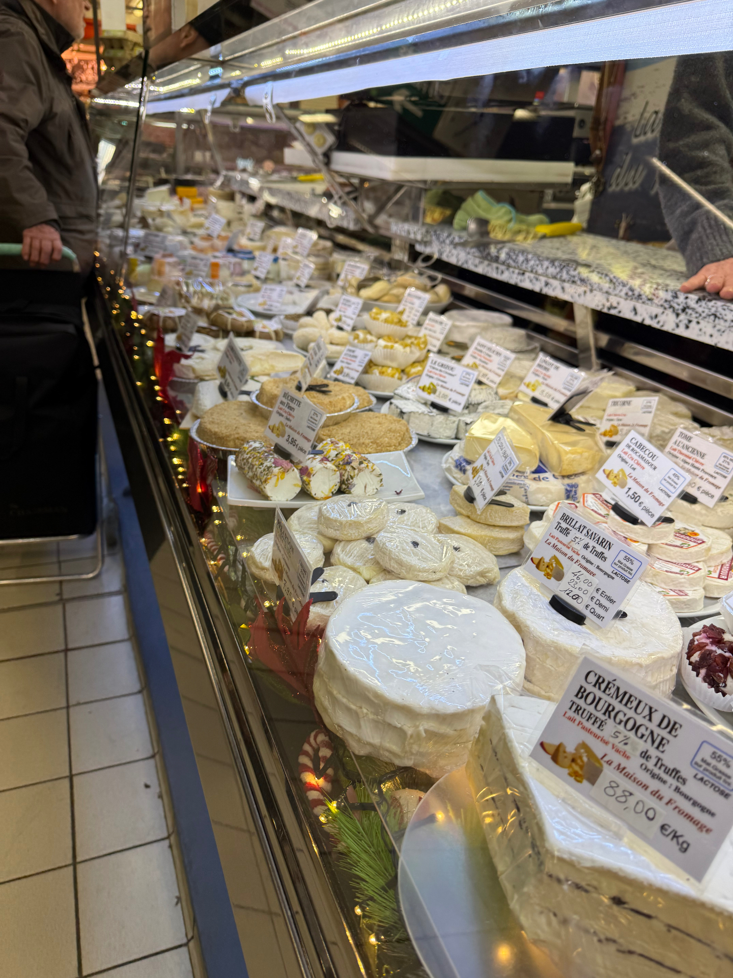 Artisan French fromagerie counter with Vacherin Mont d'Or, Livarot AOP, Pont-l'Évêque AOP, Tête de Moine and Crémeux de Bourgogne aux truffes — cheese-course inspiration for Lovey Chef Bristol