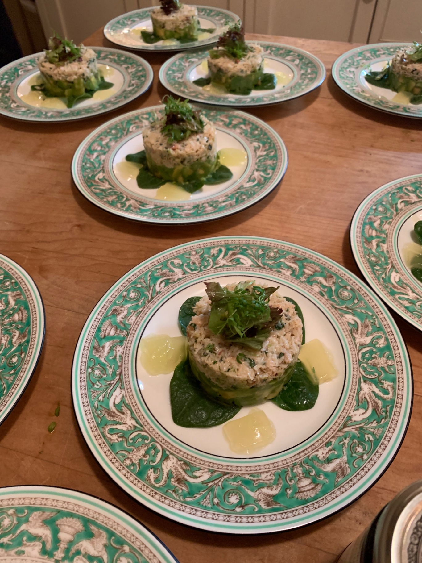 Hand-picked white crab and avocado tartare timbale on baby spinach with lemon oil pearls — fine dining seafood starter at a Lovey Chef private dinner