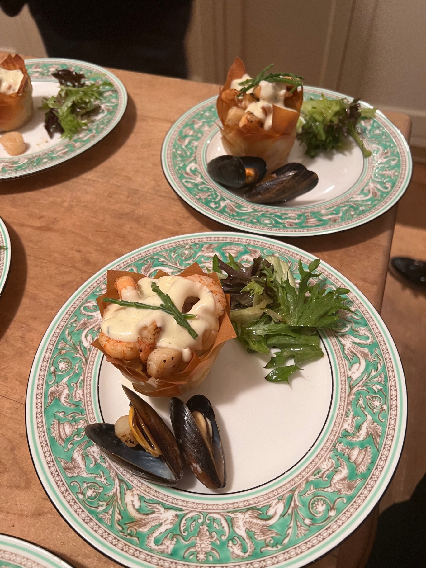 Crisp filo pastry basket of king prawns, scallops and mussels with samphire and beurre blanc — fine dining seafood starter at a Lovey Chef private dinner