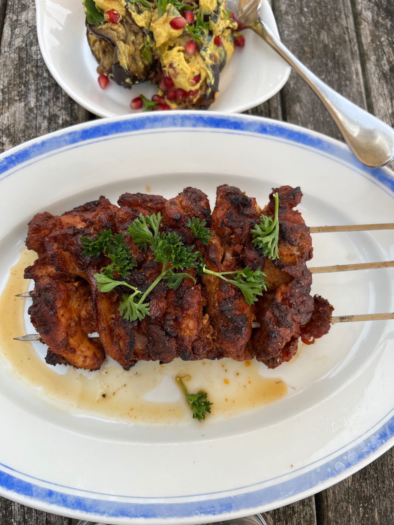 Charcoal-grilled tandoori-spiced chicken skewers with roasted aubergine, yoghurt and pomegranate — Lovey Chef private BBQ main course in the South West