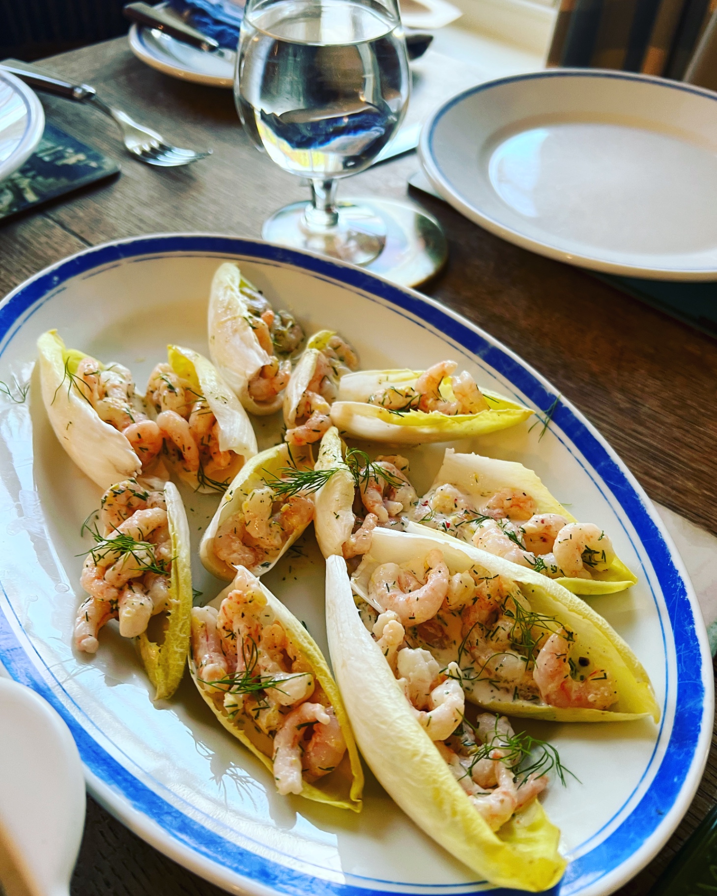 Cold-water prawns in dill crème fraîche served in white chicory boats — a light starter ahead of a Lovey Chef private BBQ