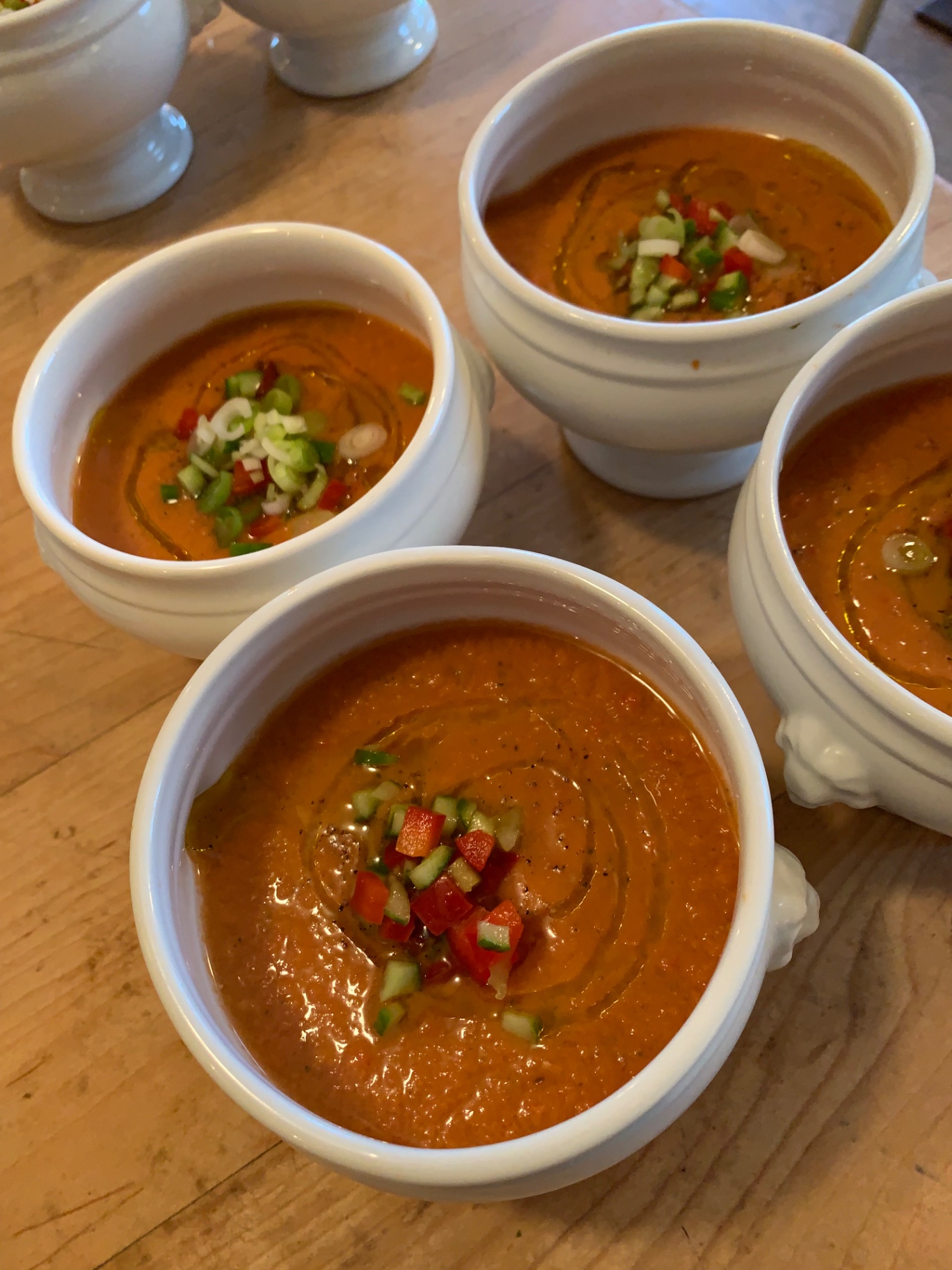 Chilled Andalusian gazpacho with red pepper, cucumber and spring onion brunoise, finished with extra-virgin olive oil — fine dining summer soup at a Lovey Chef private dinner