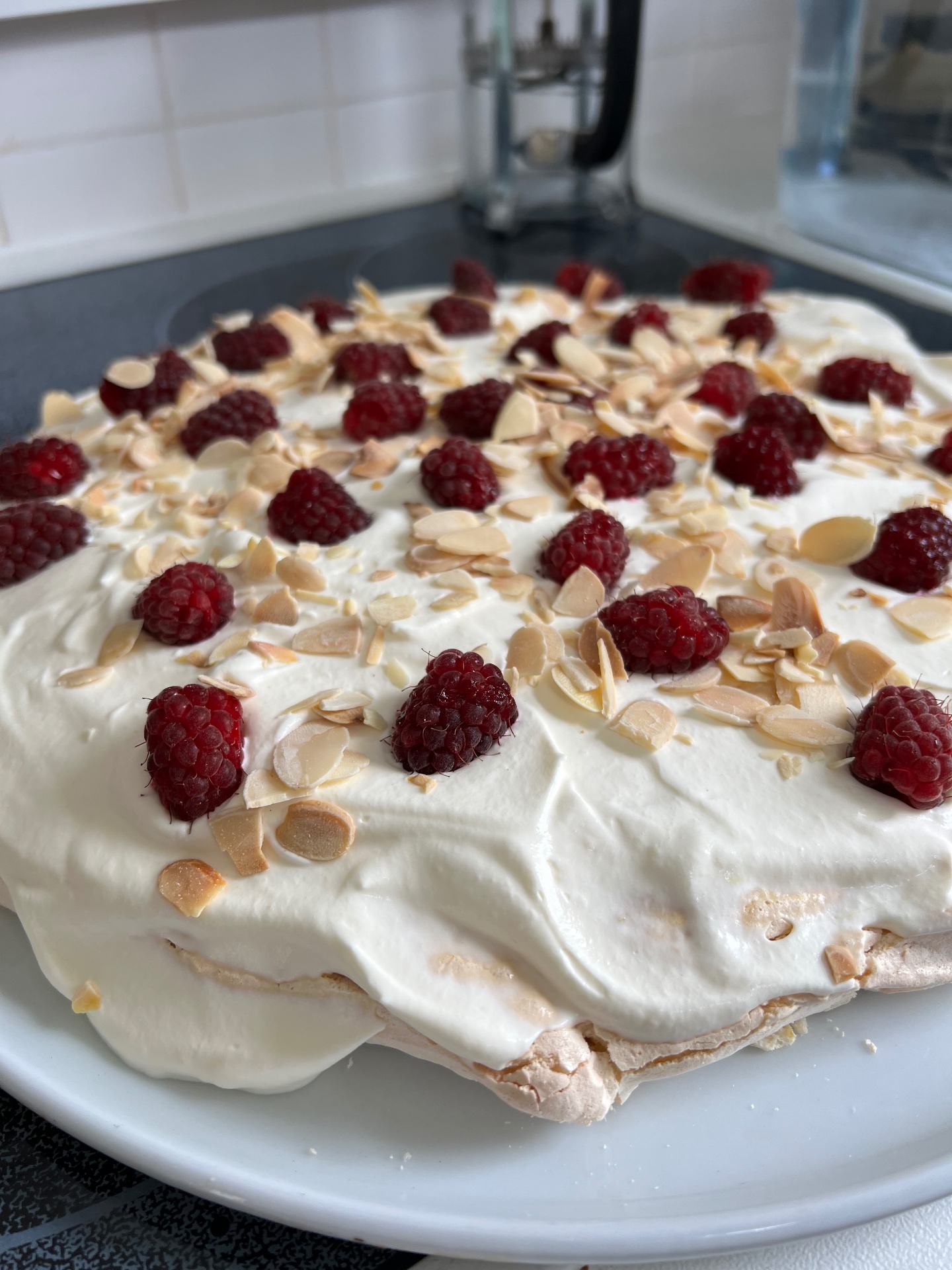 Raspberry and toasted almond pavlova with Chantilly cream and fresh raspberries — a light seasonal fruit dessert served at a Lovey Chef private dinner in Bristol