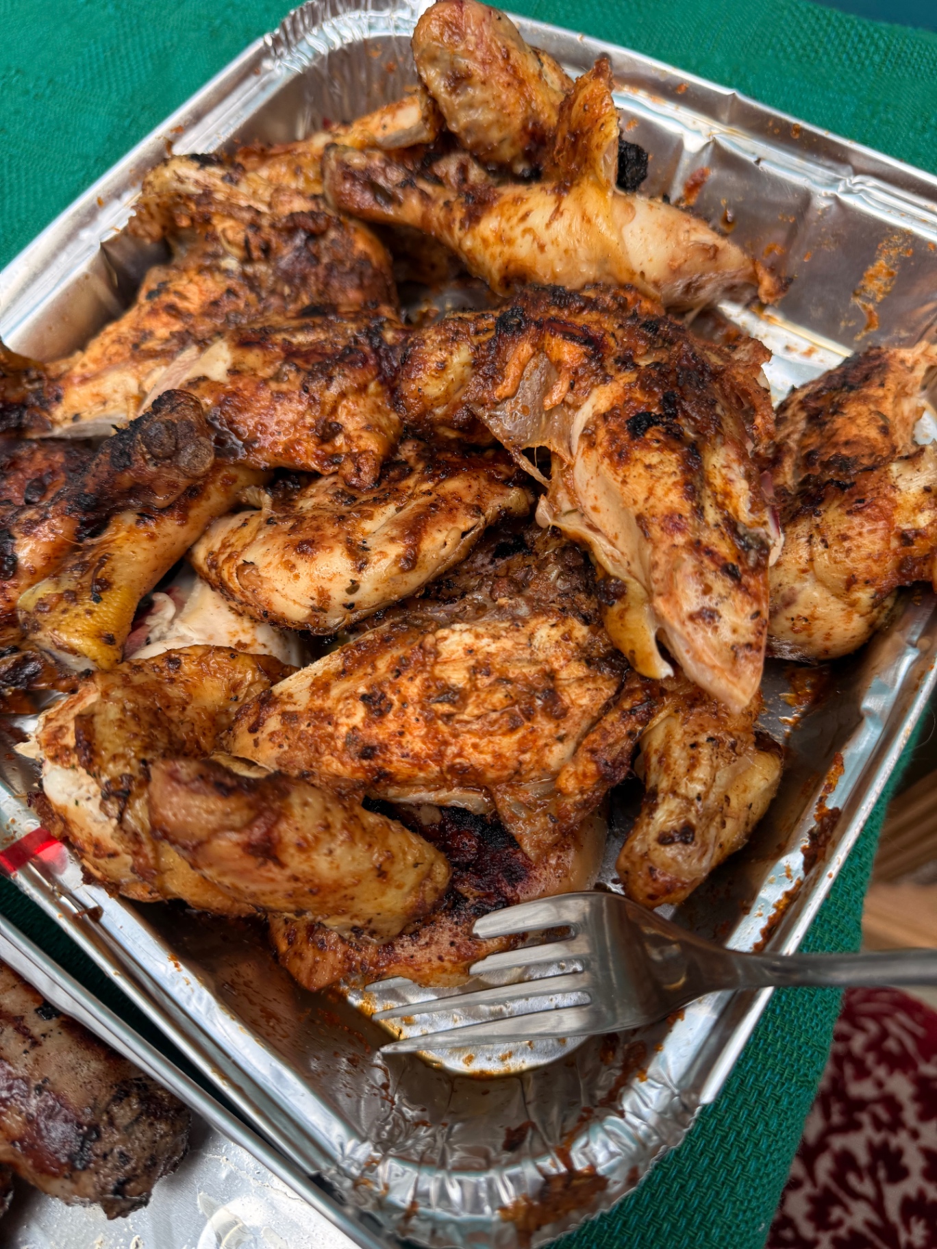 Smoky paprika-rubbed spatchcock free-range chicken pieces rested in a tray, ready to carve at a Lovey Chef private BBQ in Bristol