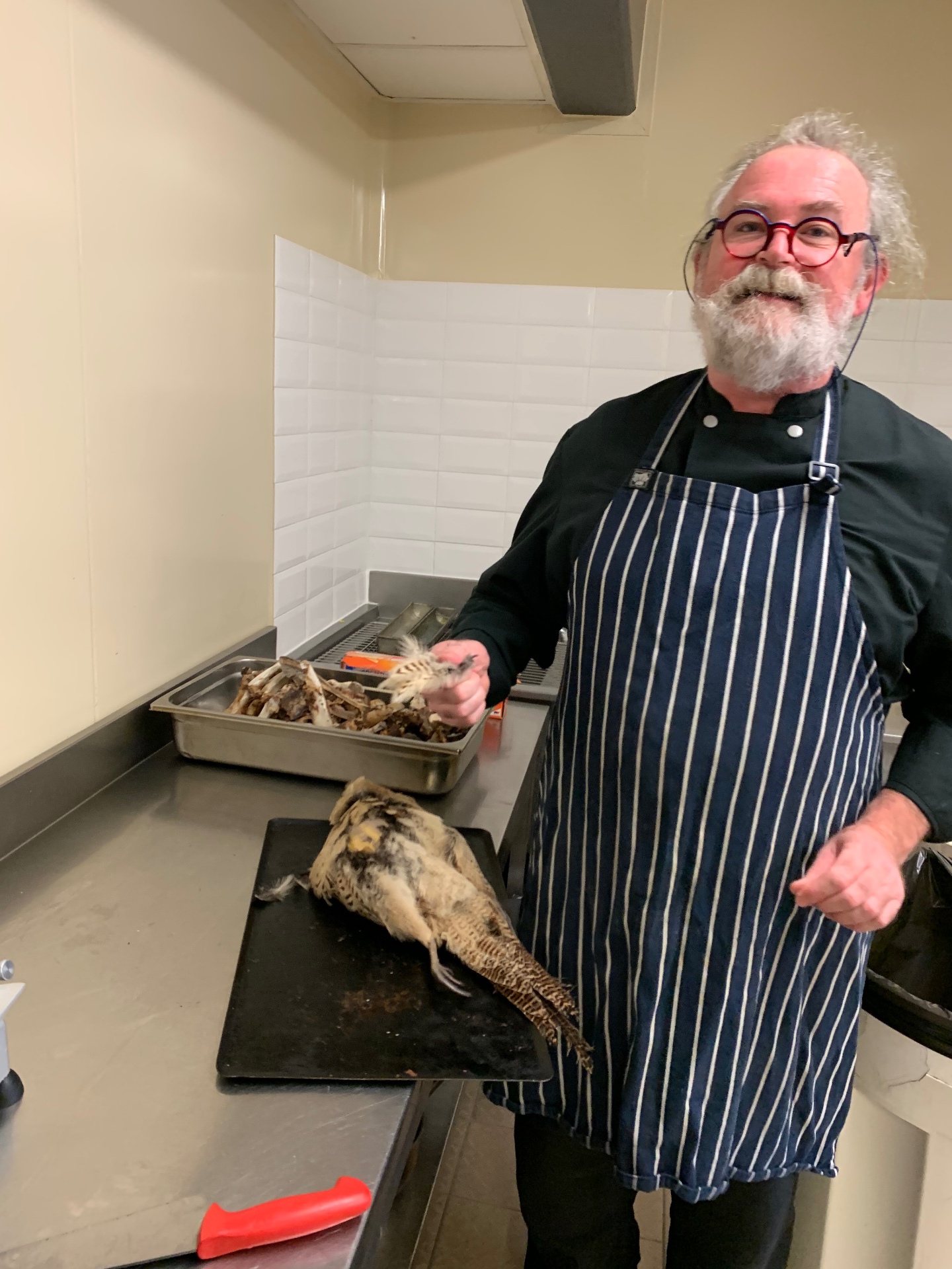 Angus 'Gus' Longstaff — The Lovey Chef in a professional kitchen preparing game for a personal chef at home service in Bristol