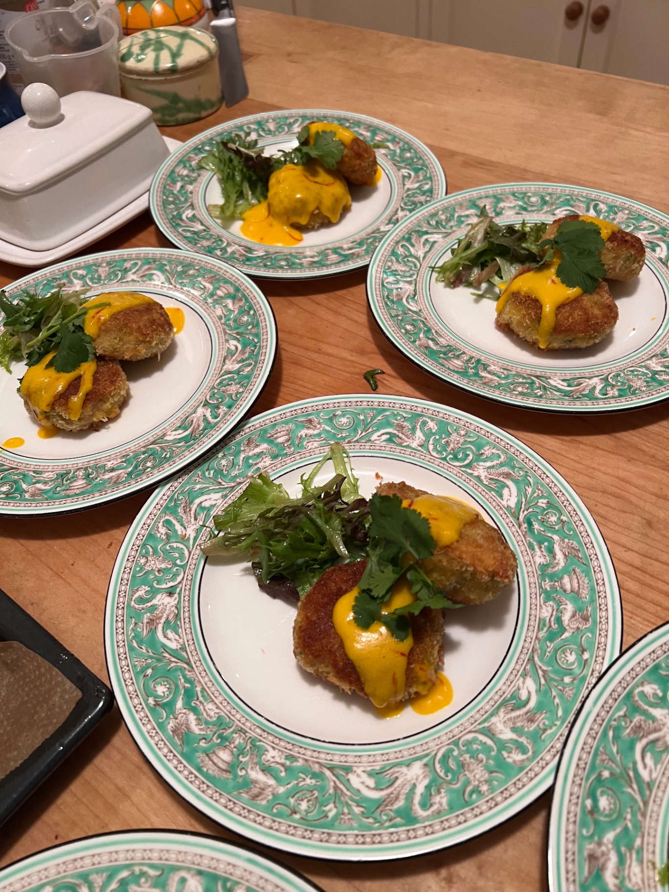 Golden panko-crumbed Thai-spiced crab cakes with saffron aioli, coriander and dressed leaves — fine dining canapé starter at a Lovey Chef private dinner